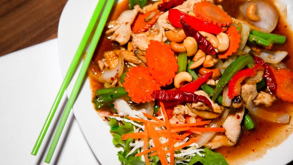 Cashew Chicken · Stir-fried chicken with cashew nuts, onions, bell peppers, mushrooms, carrots, celery, and cabbage in chili sauce.
