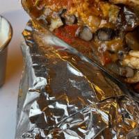 Fajita Burrito · Chicken fajitas, beans, pico de Gallo, sour cream, cheese, onions, and peppers wrapped in a ...