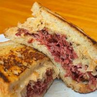The Reuben · House made corned beef on onion rye with sauerkraut, thousand island dressing, and Swiss che...