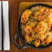 Orange Chicken · Crispy golden chicken breast nuggets caramelized in a Citrus Mandarin orange sauce.