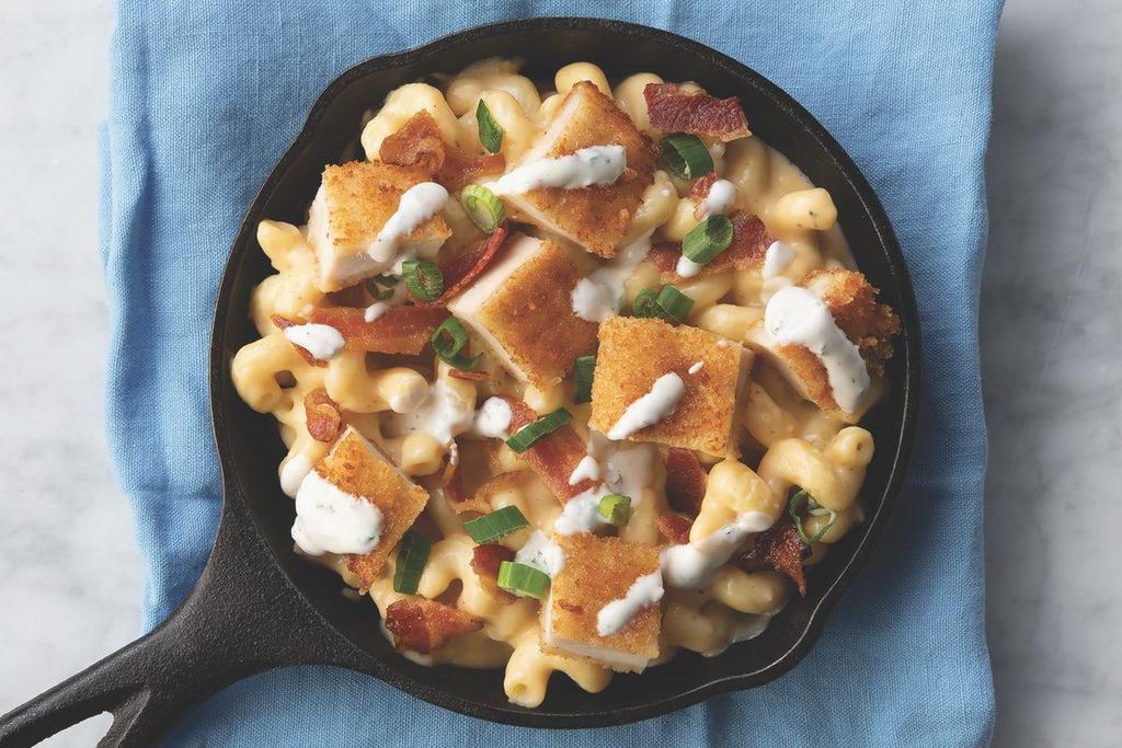 Chicken Bacon Ranch · A bed of cavatappi pasta with crispy chicken, applewood smoked bacon, shredded cheese, and a ranch drizzle.