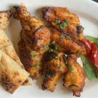 Jumbo Calabrian Chicken Wings · Coal-fired chicken wings served with a sweet and spicy Calabrian chili sauce. Served with Fo...