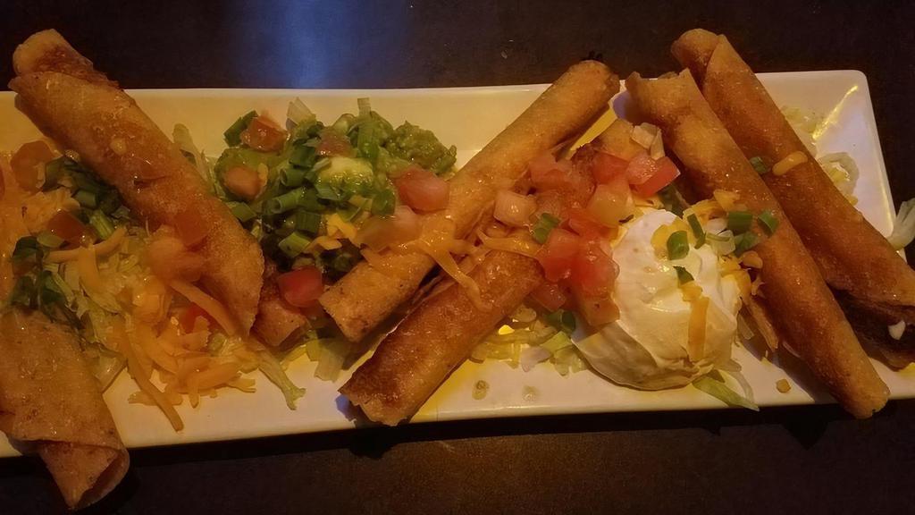 Mexican Taquitos · Rolled corn tortillas filled with chicken or picadillo. Served with guacamole, sour cream, and tomatoes.