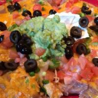Mexican Pizza · Deep-fried flour tortilla, topped with beans, choice of meat (beef, chicken, or picadillo), ...