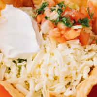 Taco Salad · Our traditional taco salad is served on a crisp flour tortilla shell with cheese melted over...
