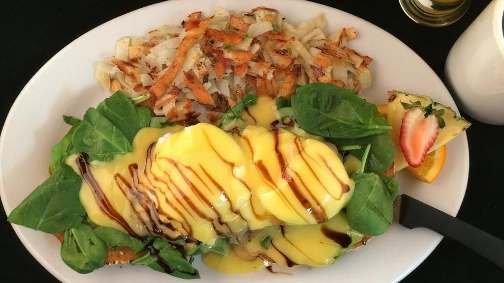 Avoveggie-N-Eggs Benedict · avocado mashed on english muffin. grilled tomato, spinach, poached eggs, hollandaise, aged-balsamic, hash brown (contains green onion)