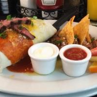 Grilled Carne Asada Steak Burrito · flour tortilla, eggs, jalapenos, cilantro and avocado. Smothered in verde and rojas sauce, w...