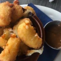 Fried Cheese Curds & Curry Dip · Breaded and fried Cheddar cheese curds, with a British spicy curry dip.