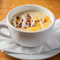 Potato Soup · Topped with bacon bits, cheddar, and sour cream.