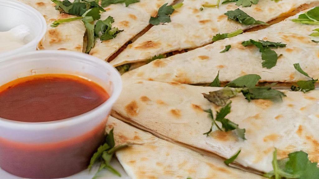 Fully Loaded Quesadilla · Stuffed with chorizo and topped with cilantro, sour cream, and UB salsa.