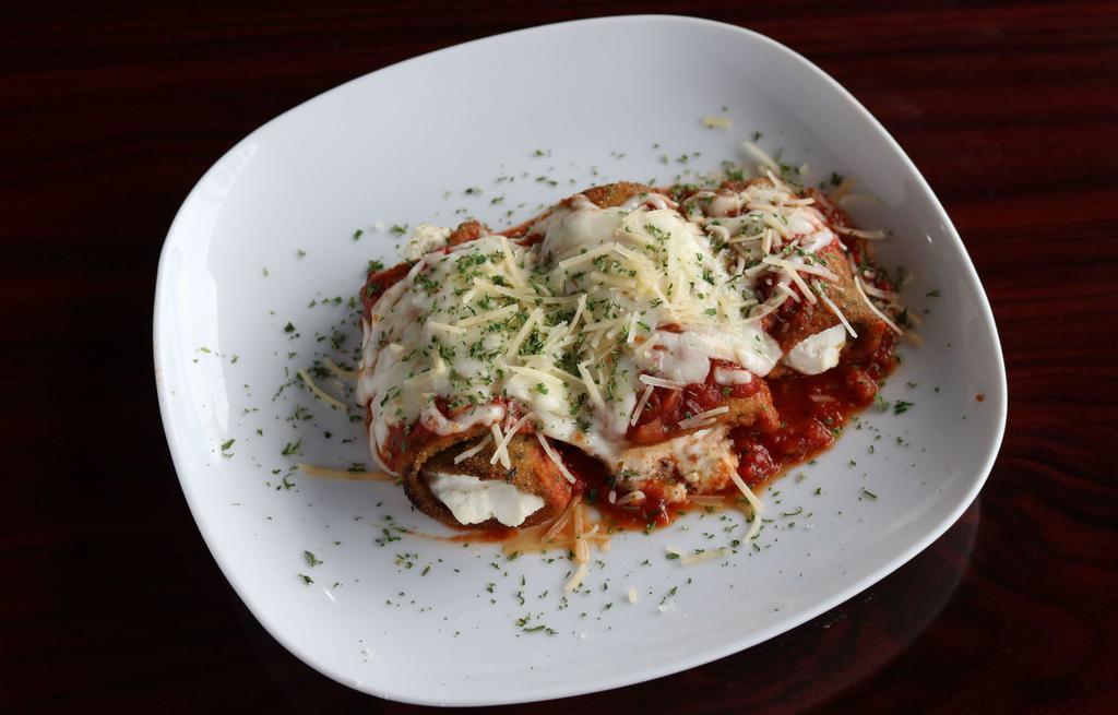 Eggplant Rollatini · Thinly sliced Breaded Eggplant stuffed with a special seasoned Ricotta Cheese covered with Marinara, melted Mozzarella Cheese and baked to perfection.