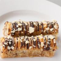 Baklava Chocolate Rolls (2Pc) · Layers of honey glazed crispy phyllo pastry, rolled and filled with crushed nuts and honey, ...