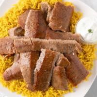 Lamb Gyro Platter · Tender slices of hand carved lamb gyro meat, served over a bed of rice, pick a side and sauc...
