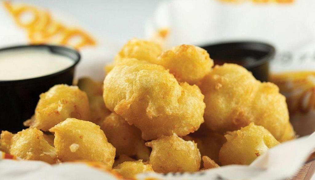Wisconsin World Famous Cheese Curds · From the cheese curd capital of the world to your mouth! Large curds of cheese, hand-dipped in our own Wisconsin beer batter and fried until golden brown. Served with your choice of dipping sauces.