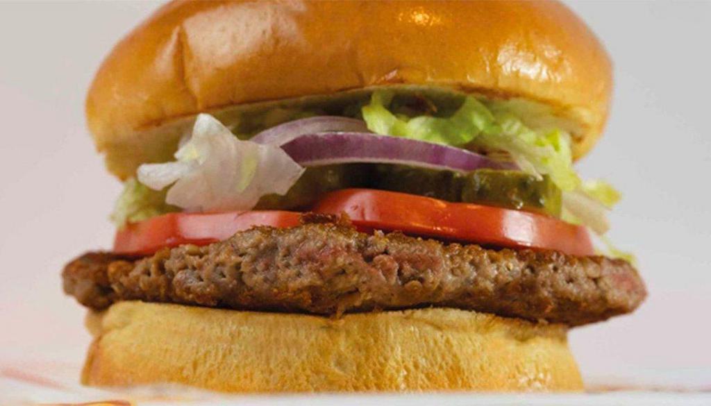 Impossible Burger · Meatless, impossible plant-based patty, in classic burger form, with lettuce, tomato, pickle, red onion on a toasted bun.