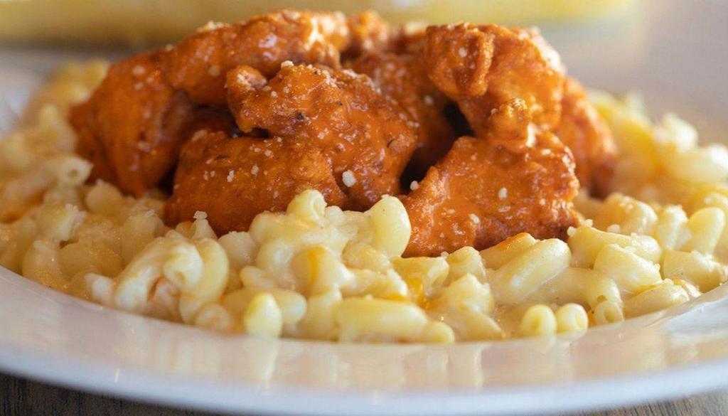 Buffalo Chicken Mac 'N Cheese · Two american favorites in a bowl. Mac 'n cheese (five cheeses) topped with boneless buffalo wings served with a warm breadstick.