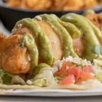 Baja Fish Street Tacos · Two street-style soft corn tortilla tacos with beer battered fish, yellow onions, avocado ai...