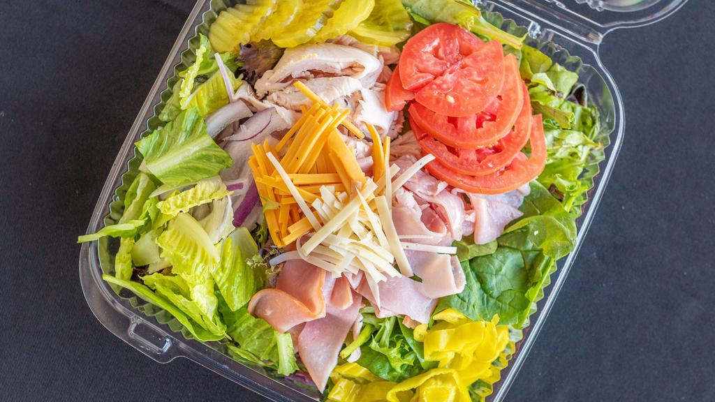 Chef'S Salad · Mixed greens and romaine, ham, turkey, tomato, American and Swiss cheese, onions, peppers and dressing.