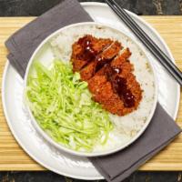 Chicken Katsu Bowl · Chicken cutlet laid over the top of rice. Served with cabbage and a side of tonkatsu sauce