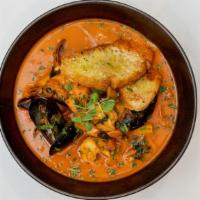 Cioppino · Seaffod stew with Chilean seabsaa, salmon, shrimps, clams and mussels in a savory broth with...