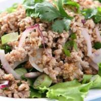 Larb Kai (Chicken) · Minced chicken, tossed in hot spicy lime sauce, roasted rice, onion, cilantro.