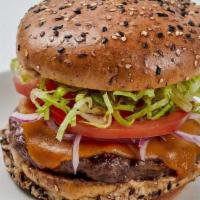 100% Grass-Fed Cheeseburger* · special sauce, cheddar cheese, tomato, lettuce, red onion, flaxseed bun
