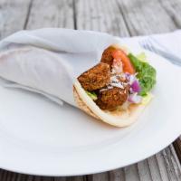 Falafel Gyro · Soft and warm pita bread, misted in olive oil, wrapped around spiced mashed chickpeas formed...