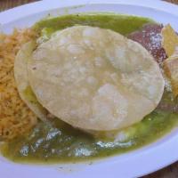 Huevos Rancheros · 2 over easy eggs inside 2 semi fried corn tortillas cover on green salsa  side of rice and r...