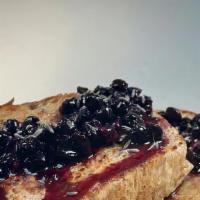 Blueberry Lavender French Toast  · Two slices of sourdough french toast topped with blueberry lavender compote, maple syrup, an...