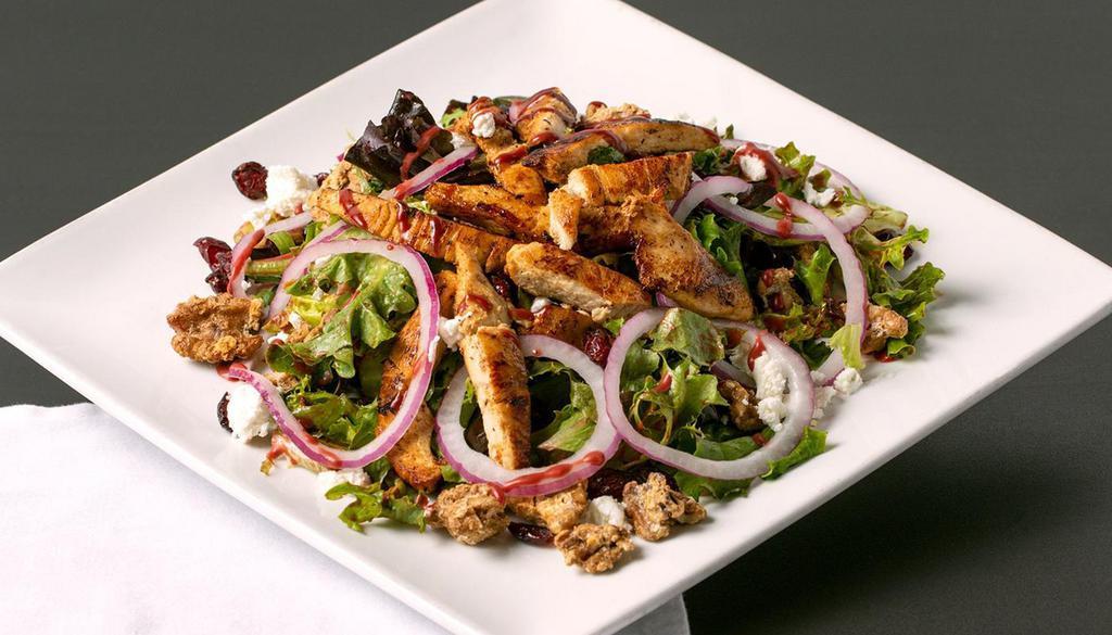 Chicken Goat Cheese Salad · Spring mix tossed in raspberry vinaigrette, topped with dried cranberries, candied walnuts, goat cheese crumbs, red onion and baked chicken breast.