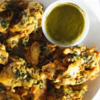 Mix Veg Pakora · A quick snack recipe made of spinach, onion, cauliflower & potatoes in spices and gram flour.