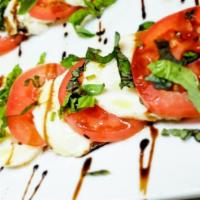 Caprese Salad · Layers of fresh mozzarella, Roma tomatoes, and basil drizzled with olive oil and balsamic re...