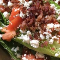 Wedge Salad · topped with Bleu Cheese crumbles & served with Bleu Cheese or Ranch dressing