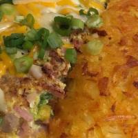 Kitchen Sink Omelette · Ham, bacon, sausage, mushrooms, bell peppers and onions topped with combo cheese and green o...