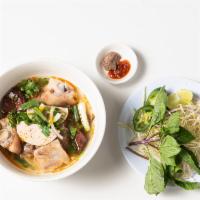 Bún Bò Huế · Spicy noodle soup with beef shanks, pork hock pork blood, Vietnamese pork ham (chả lụa) & ve...