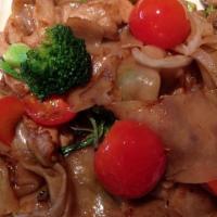 Pad Kee-Mao · Spicy wide rice noodles stir-fried with fresh Thai chili and garlic, cherry tomatoes, sweet ...
