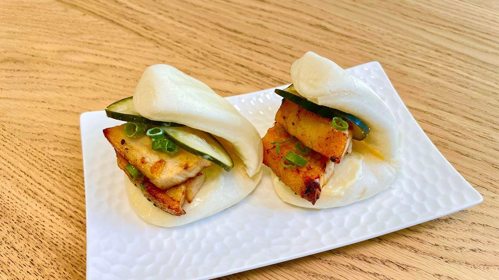 Pork Buns · Steamed bun with oven roasted confit pork belly, pickled cucumber, scallions, japanese mayo and hoisin sauce. 
(2 per order)