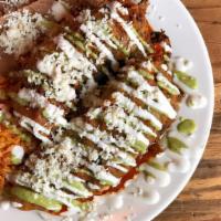 Chile Rellenos (Online) · Two deep-fried poblano peppers topped with cheese, sour cream, avocado cream, and red enchil...