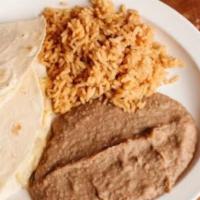 Kids Quesadilla (Online) · Small flour tortilla, with cheese and/or chicken, served with a side of red rice and refried...
