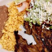 Carne A La Tampiquena · Asada steak with two red chicken enchiladas topped with cheese and sour cream, no tortillas ...