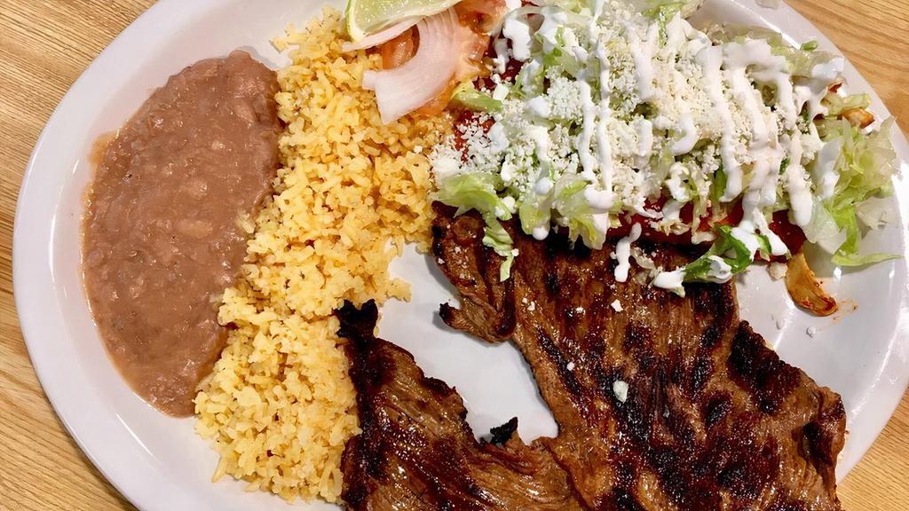 Carne A La Tampiquena · Asada steak with two red chicken enchiladas topped with cheese and sour cream, no tortillas pollo.