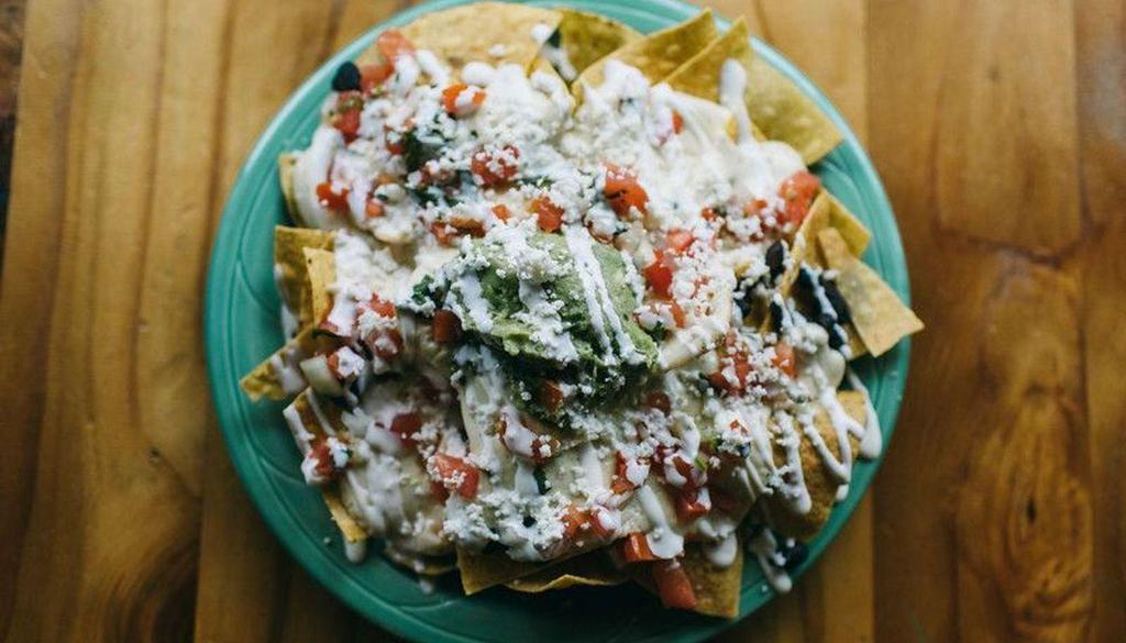Nachos · Made with your choice of meat or veggies, black beans, cheese, guacamole, crema Mexicana, and salsa Fresca.