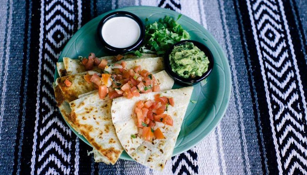 Quesadilla · A large flour tortilla filled with your choice of meat or veggies and melted Jack cheese. Served with guacamole, sour cream, and salsa fresca