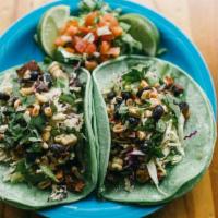 Taco- Tempeh · Marinated tempeh in cactus infused tortillas with red/green cabbage, cashew garlic sauce, bl...