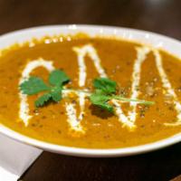 Dal Makhani · Whole black lentils, tomato, garlic, ginger, tomato, butter & cream cooked on slow fire.