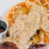 Chicken And Waffles · Belgian waffle, signature sausage gravy, crispy fried chicken breast with side of applewood ...