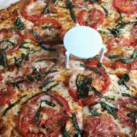 Margherita Pizza · Roma tomatoes and fresh basil with olive oil and garlic white sauce instead of marinara sauce.