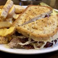 Reuben Sandwich · Hand-carved corned beef on deli-rye bread served with sauerkraut, thousand island, and swiss...