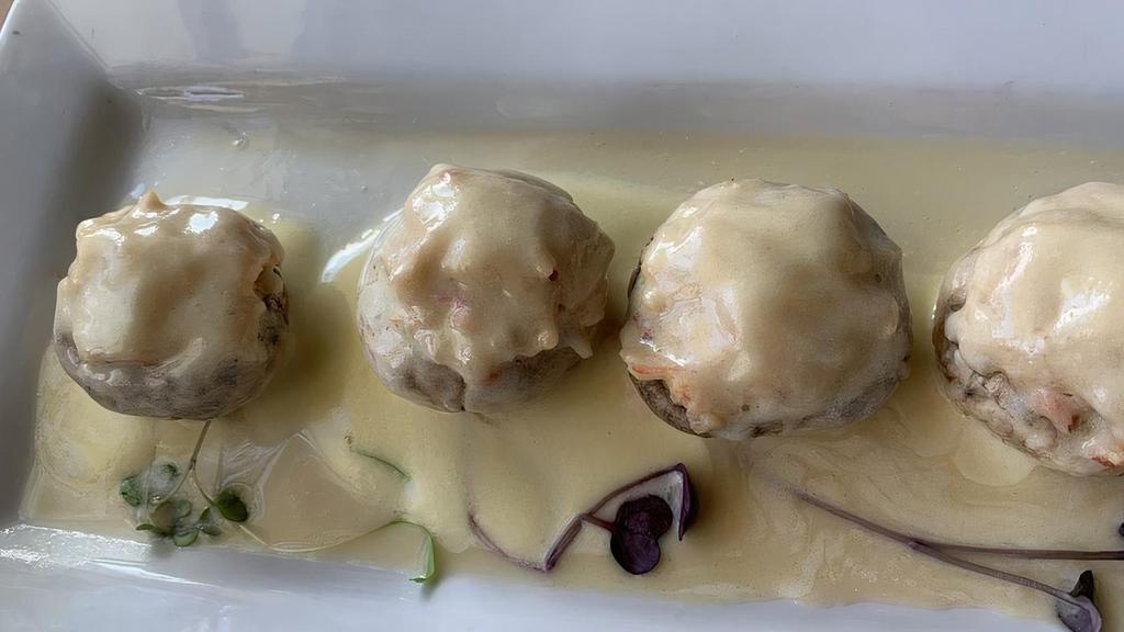Crab Stuffed Mushrooms · Wild mushroom caps filled with crab meat, dressed with tequila lime beurre blanc sauce.