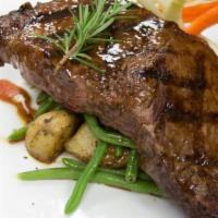 14 Oz. Rib Eye Steak Center Cut* · Cooked to perfection, served with fresh garden vegetables.
